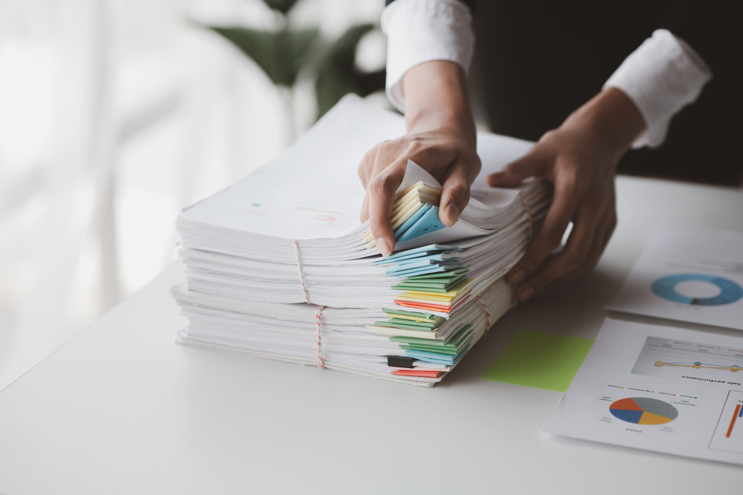 A neatly organized stack of financial documents on a desk, ready for audit.