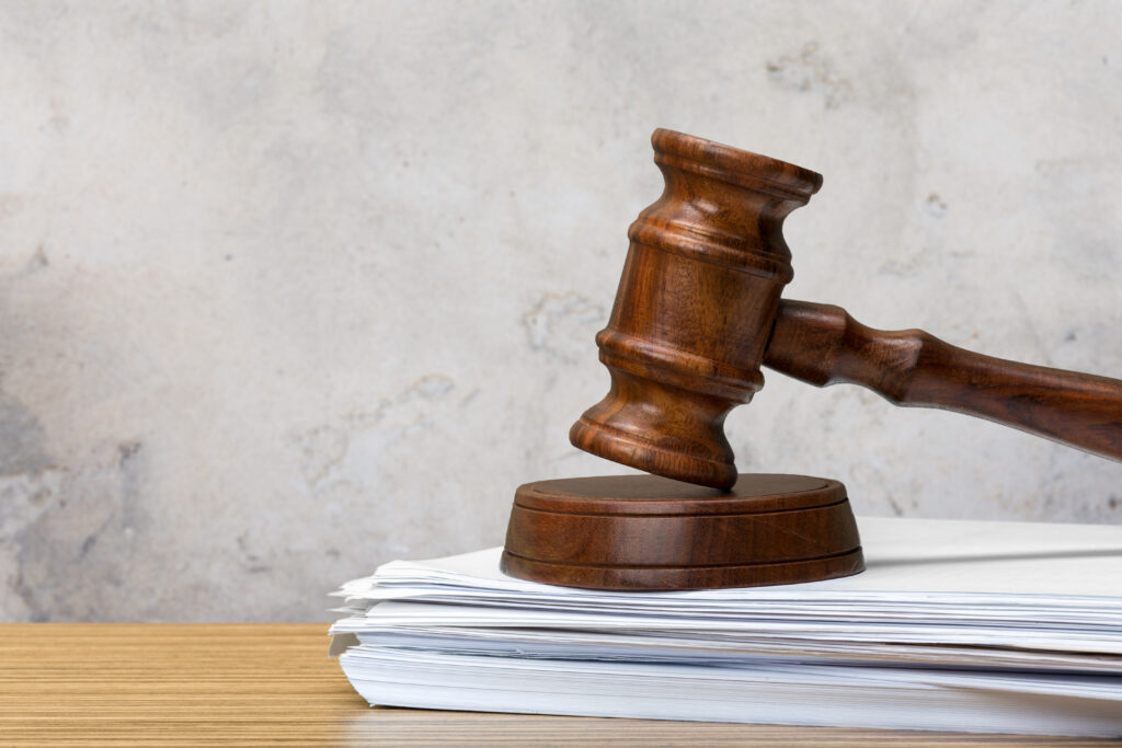 Close-up of legal documents and a gavel, representing payroll compliance.