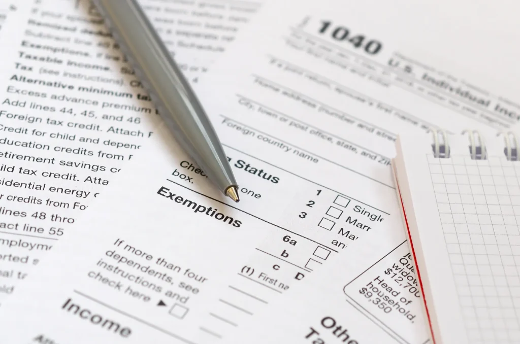Close-up view of an tax form and a pen, symbolizing the application process.