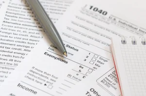 Close-up view of an tax form and a pen, symbolizing the application process.